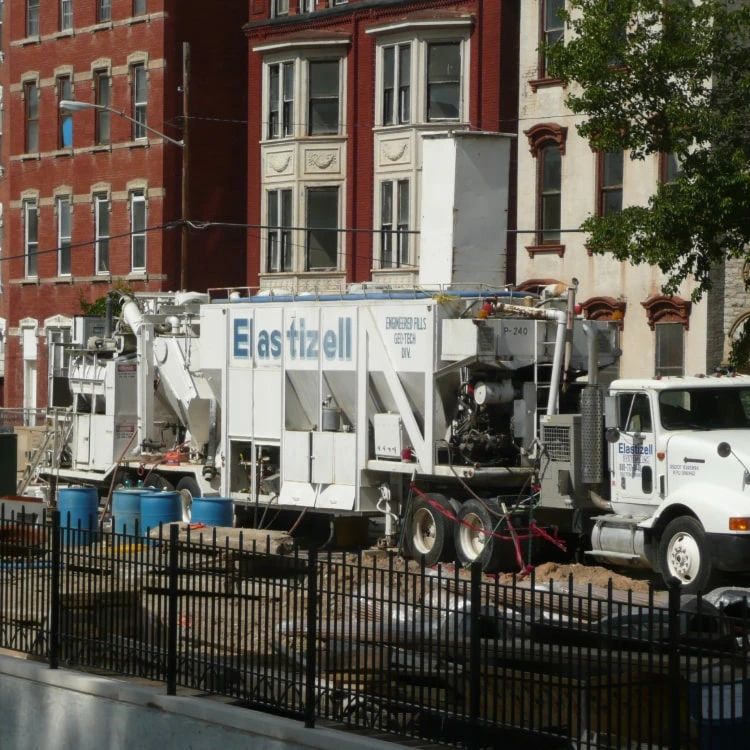 Elastizell Systems workers applying lightweight cellular concrete as plaza fill in Cincinnati, Ohio, using specialized equipment